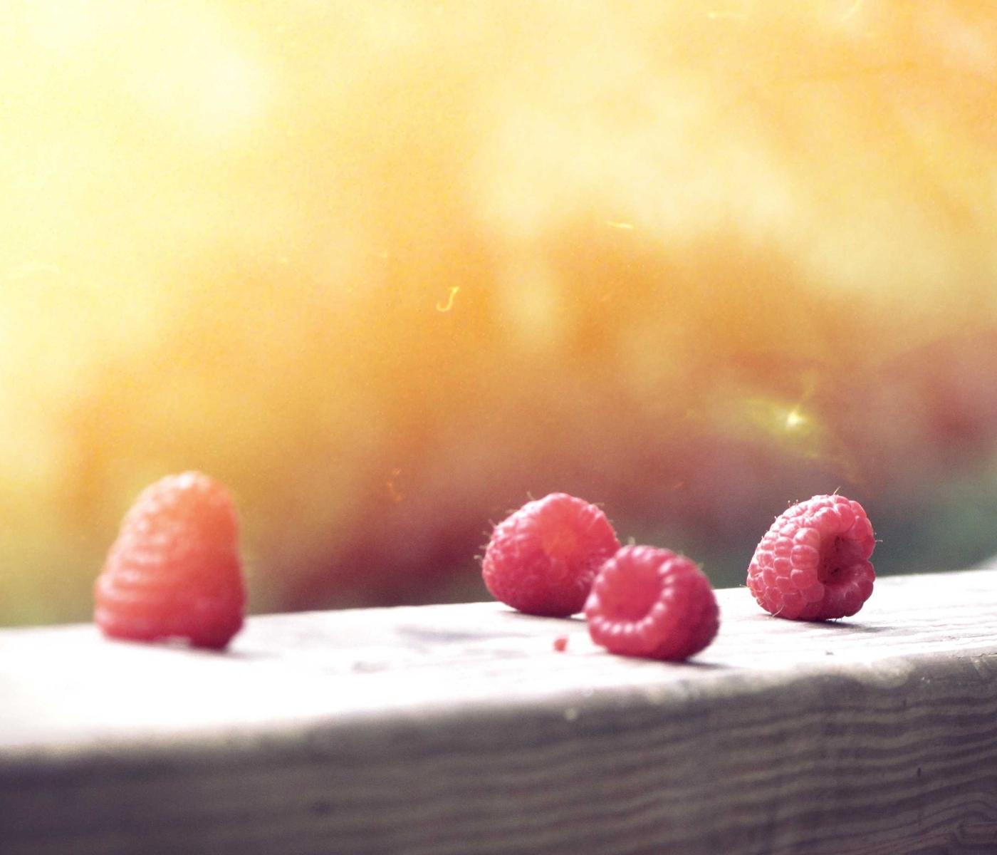 Fresh raspberries in warm natural light